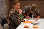 Chief Master Sgt. Michelle Siau swabs the inside of her cheek at the National Guard Bureau's Joint Force Headquarters in Arlington, Va., June 5 during a bone marrow donor drive. More than 330 Guard members and government service workers registered with the C.W. Young Department of Defense Marrow Donor Program that day.