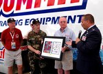 Ray Tatko (third from left) receives a plaque from Ron Steger, Air Guard Master Sgt. William Raby and Air Guard Capt. John Glasgow during the Super Summit XV event June 16, 2007. Tatko is the president of Summit Racing Equipment that supports anti-drug and other youth efforts in the community.