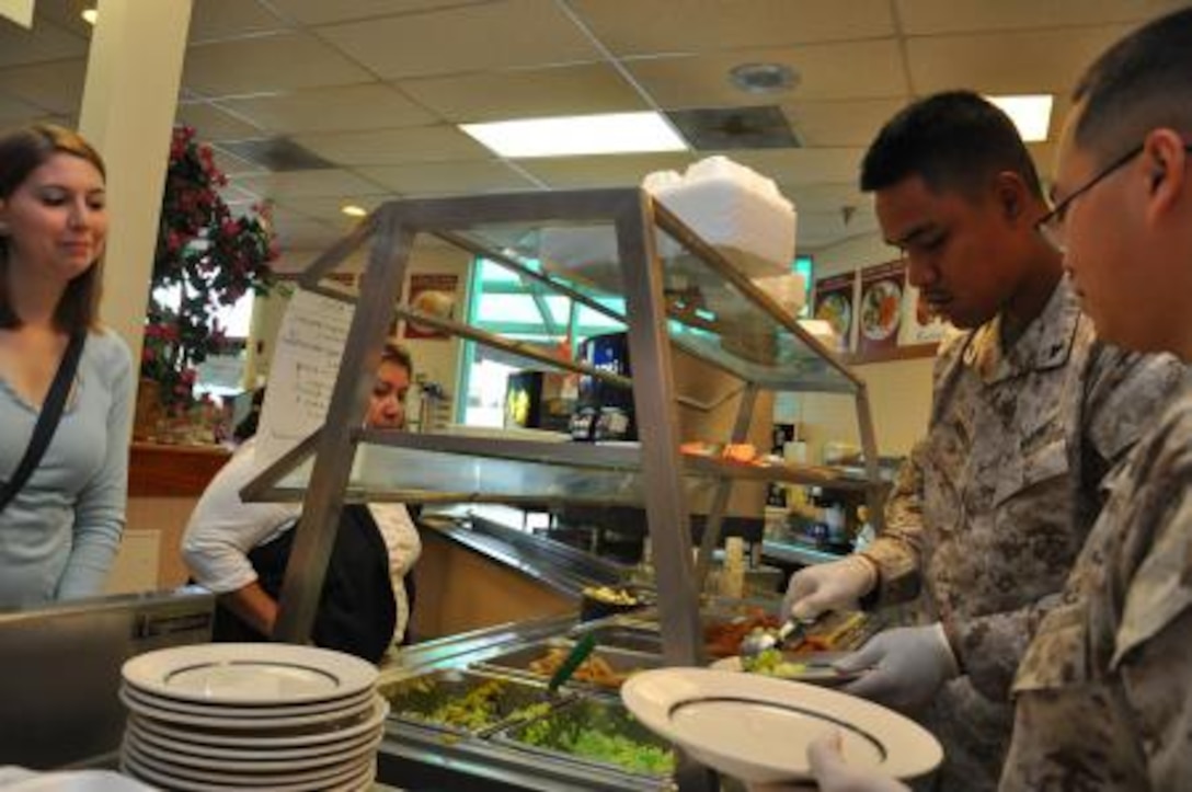 Lance Cpls. Jonathon Norita and Blong Yang, Marines of Marine Corps Logistics Base Barstow, serve food during the 4th annual Green Eggs and Ham breakfast held March 18 at the base’s Family Restaurant.
