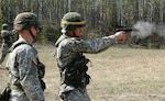 Staff Sgt. Steven Mich evaluates the handling of a German pistol during a German marksmanship competition held by the 49th Missile Defense Battalion.