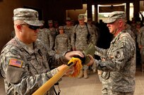 Command Sgt. Maj. Brian Sann, left, brigade sergeant major for the 58th Brigade Combat Team, left, and Col. Sean Casey, commander of the 58th BCT, uncase the unit's colors during a transfer of authority ceremony in which the 58th BCT assumed responsibility for garrison operations of Victory Base Complex, Iraq, from the 38th Division Support Command, Tuesday, July 10, 2007. The 58th BCT will be responsible for all daily operations on VBC.(U.S. Army photo by Staff Sgt. Jon Soucy) (Released)