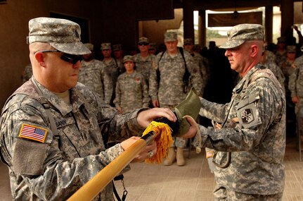 Command Sgt. Maj. Brian Sann, left, brigade sergeant major for the 58th Brigade Combat Team, left, and Col. Sean Casey, commander of the 58th BCT, uncase the unit's colors during a transfer of authority ceremony in which the 58th BCT assumed responsibility for garrison operations of Victory Base Complex, Iraq, from the 38th Division Support Command, Tuesday, July 10, 2007. The 58th BCT will be responsible for all daily operations on VBC.(U.S. Army photo by Staff Sgt. Jon Soucy) (Released)