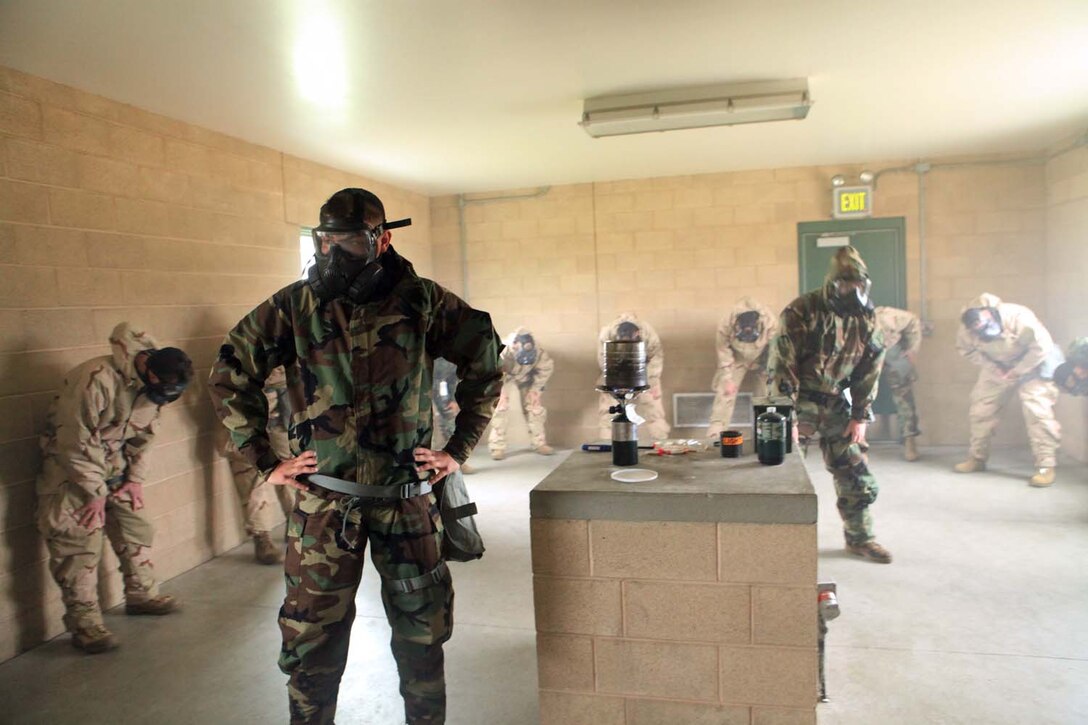 Chemical, biological, radiological, nuclear defense instructors with 9th Communication Battalion, instruct a group of I Marine Expeditionary Force Marines during gas chamber training at Camp Pendleton, Calif., March 26. The gas chamber is a required annual training for Marines. The training provides Marines with a basic knowledge of how to don and clear a gas mask to effectively defend against chemical or biological assaults.
