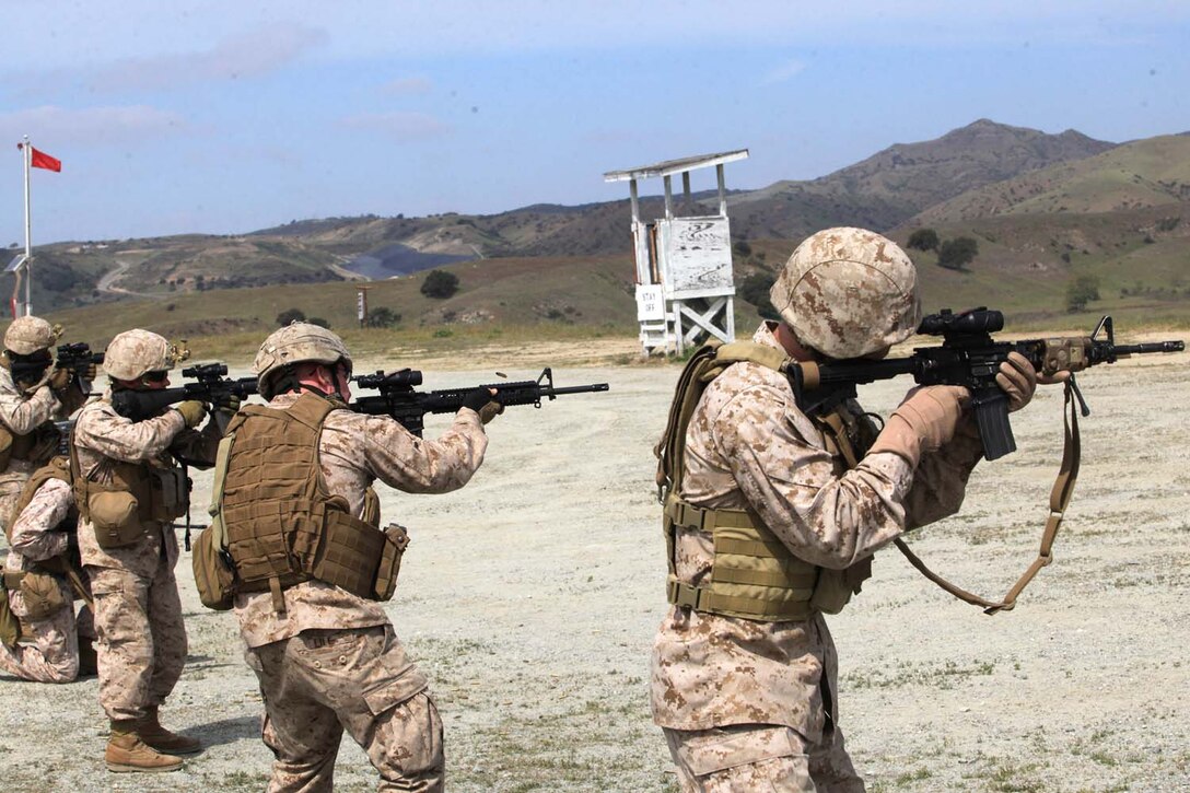Marines with 1st Air Naval Gunfire Liaison Company, I Marine Expeditionary Force, conduct a firing drill during an enhanced marksmanship program, at Camp Pendleton, March 27. The training is designed to increase Marines close range marksmanship skills by running multiple drills numerous times.