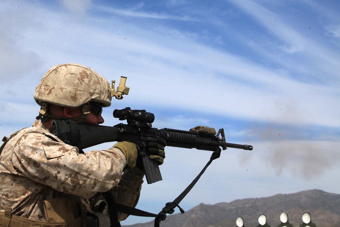 Lance Cpl. Brandon Howell, a radio technician with 1st Air Naval Gunfire Liaison Company, I Marine Expeditionary Force, from Wichita, Kan., feels his M16A2 service rifle recoil after firing it during an enhanced marksmanship program, at Camp Pendleton, March 27. The training is designed to increase Marines close range marksmanship skills by running multiple drills numerous times.