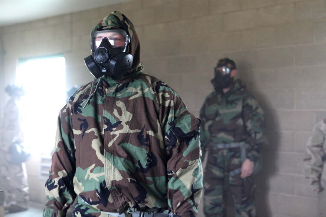 Cpl. Ronald Isaacs, 24, from Bluff City, Tenn., a chemical, biological, radiological, nuclear defense chief with 9th Communication Battalion, I Marine Expeditionary Force, instructs I MEF Marines on the procedures to don and clear a gas mask inside a gas chamber at Camp Pendleton, Calif., March 26. The training provides Marines with a basic knowledge of how to don and clear a gas mask to effectively defend against chemical or biological assaults.