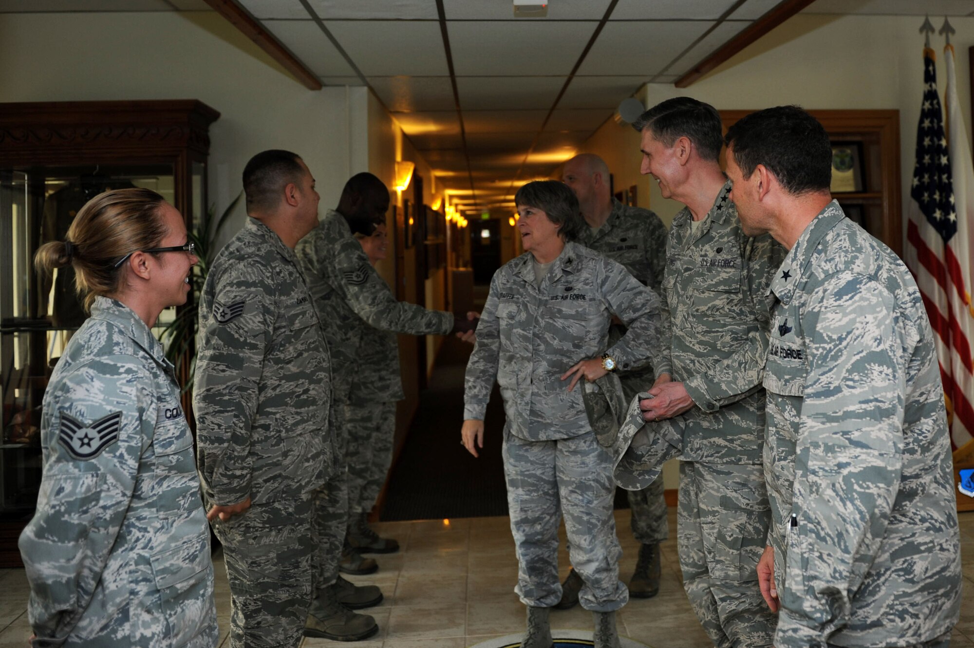 U.S. Air Force Lt. Gen. Richard Harding, The Judge Advocate General (TJAG), and Col. Sharon Shaffer, Staff Judge Advocate, Headquarters, Pacific Air Forces, greet 18th Wing Headquarters staff at the Wing building during a visit to Kadena Air Base, Japan, March 29, 2013. During his visit, Harding took tours of the Kadena Law Office, the Tax Center, and the Area Defense Council as part of an inspection, ensuring the legal staff is in compliance with regulations. (U.S. Air Force photo/Airman 1st Class Hailey R. Davis)
