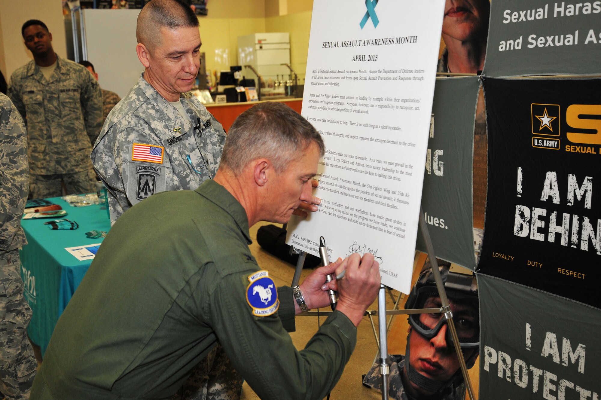 Col. Patrick McKenzie, 51st Fighter Wing commander, signs the Sexual Assault Awareness Month Proclamation on Osan Air Base, April 1, 2013.  April is national sexual assault awareness month. Across the department of defense, leaders at all levels are trying to raise awareness and focus on sexual assault prevention and response through special events and education. (U.S.  Air Force photo/Staff Sgt. Emerson Nuñez)    