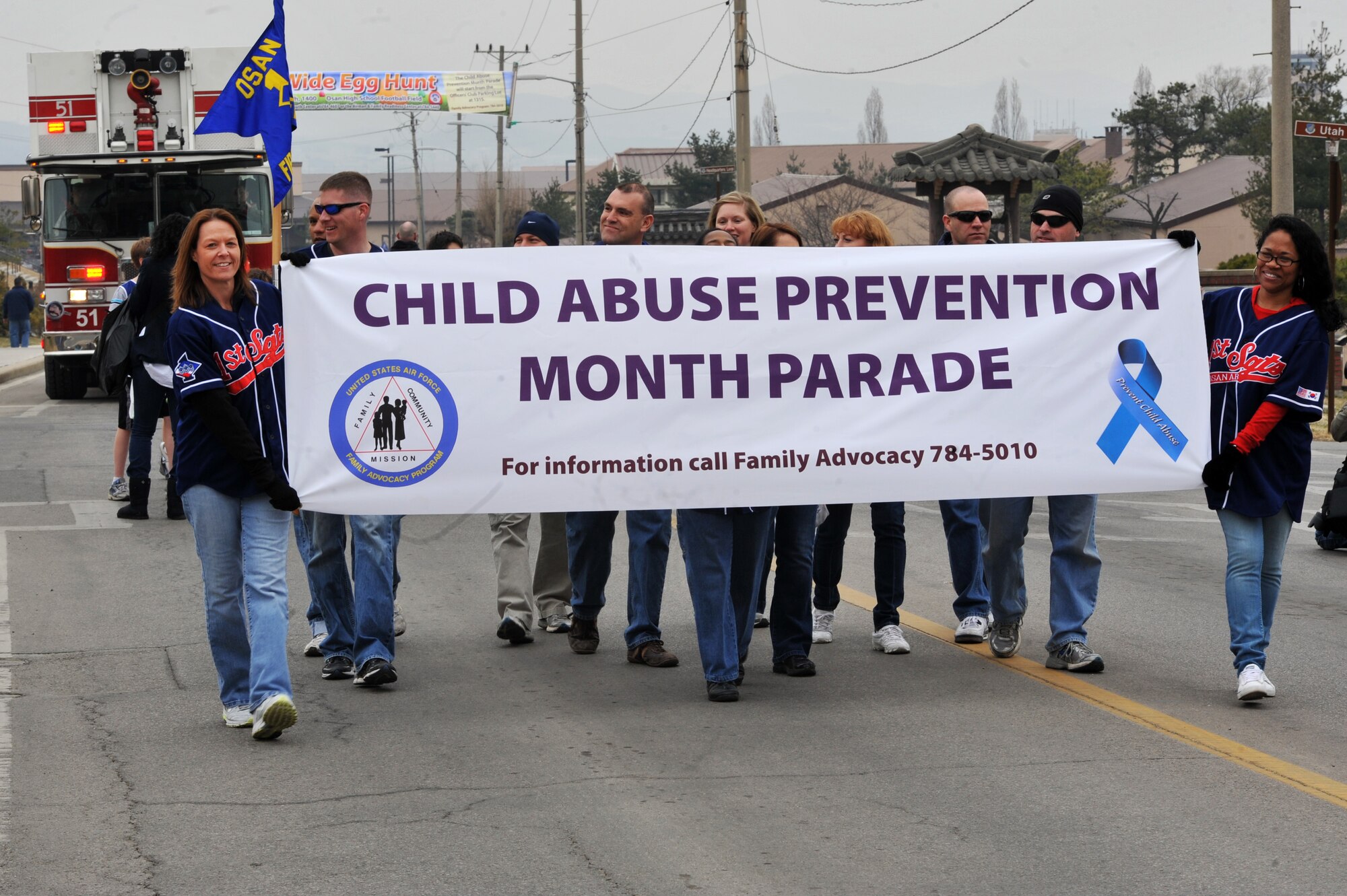 Osan first sergeants carry the child abuse prevention banner during the Child Abuse Prevention Month Parade on Osan Air Base, Republic of Korea, March 30, 2013.  The parade is held on base annually. (U.S.  Air Force photo/Staff Sgt. Emerson Nuñez)