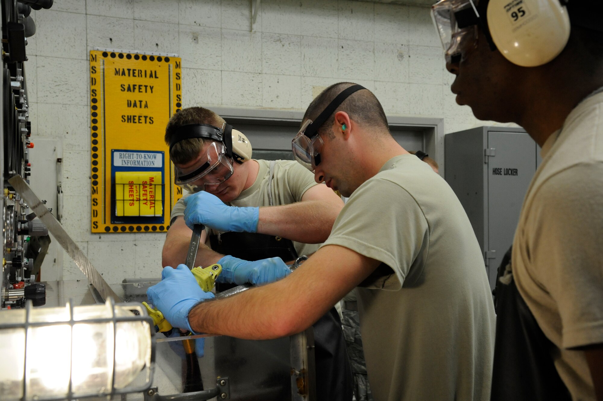 Senior Airman Jeremy Brown, 2nd Maintenance Squadron Accessories Flight Hydraulics, and Staff Sgt. Daniel Fenimore, 2 MXS Hydraulics section chief, tighten hydraulic lines on a sliding sleeve assembly on Barksdale Air Force Base, La., April 1. Hydraulics Airmen's responsibilities include maintaining the hydraulic systems of the B-52H Stratofortress which allow the aircraft to steer, land, and maneuver through the battlefield. (U.S. Air Force photo/Airman 1st Class Andrew Moua)