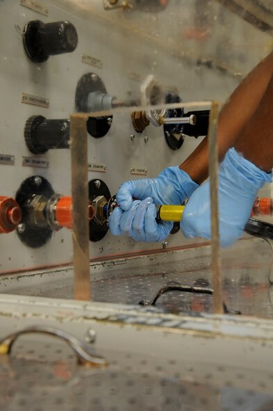 Airman 1st Class Christopher Walker, 2nd Maintenance Squadron Accessories Flight Hydraulics, attaches a hydraulic line to a hydraulic test stand on Barksdale Air Force Base, La., April 1. Once a part has finished being inspected and repaired, it is run through a hydraulic test stand which simulates the conditions the part goes through while in flight, before it is sent back to the flightline. (U.S. Air Force photo/Airman 1st Class Andrew Moua)