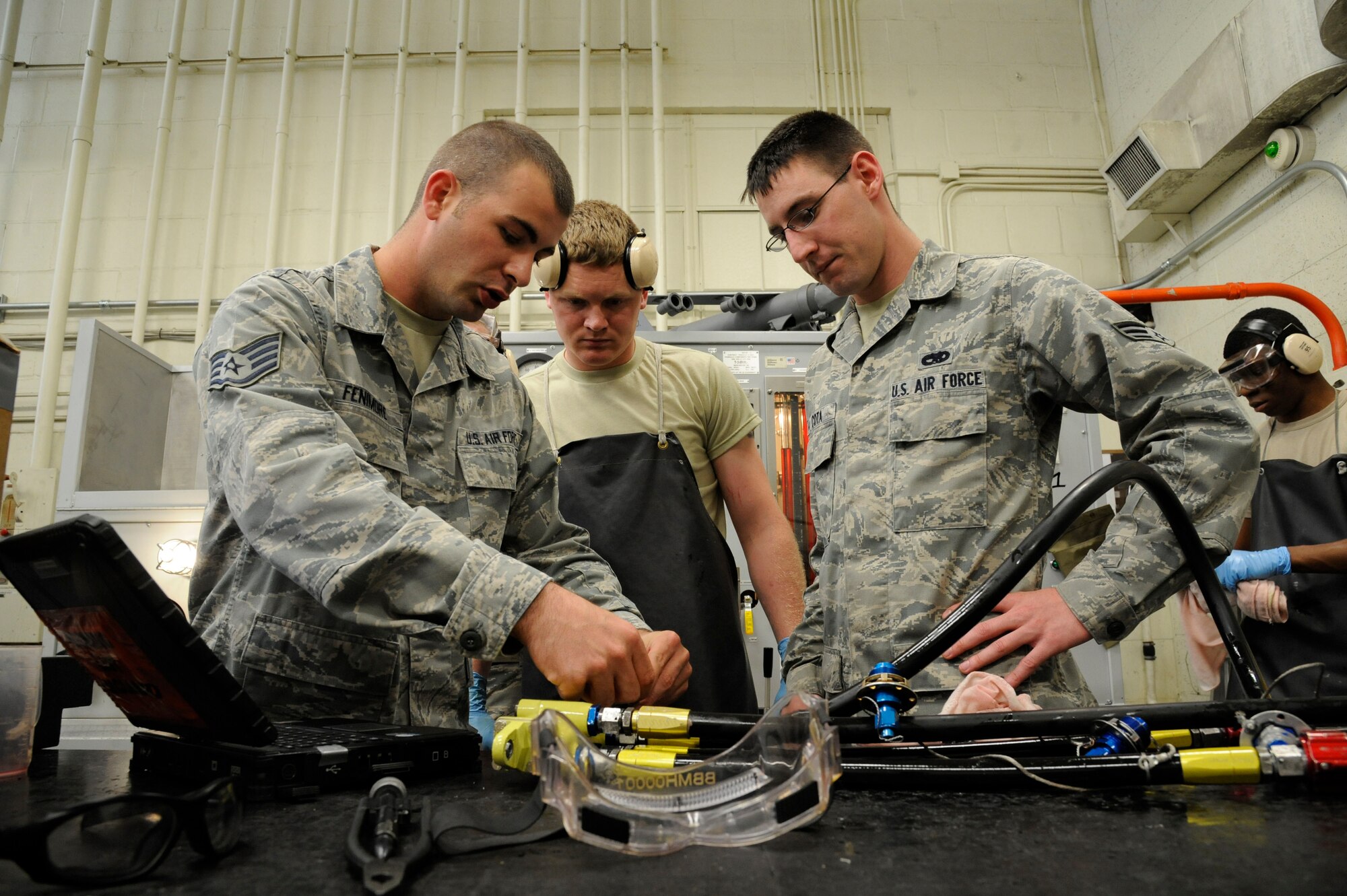 Staff Sgt. Daniel Fenimore, 2nd Maintenance Squadron Accessories Flight Hydraulics section chief, instructs Senior Airmen Jeremy Smith and Richard Cota, 2 MXS Hydraulics, on the proper way to test and inspect hydraulic parts on Barksdale Air Force Base, La., April 1. Hydraulics Airmen's responsibilities include maintaining the hydraulic systems of the B-52H Stratofortress which allow the aircraft to steer, land, and maneuver through the battlefield. (U.S. Air Force photo/Airman 1st Class Andrew Moua)