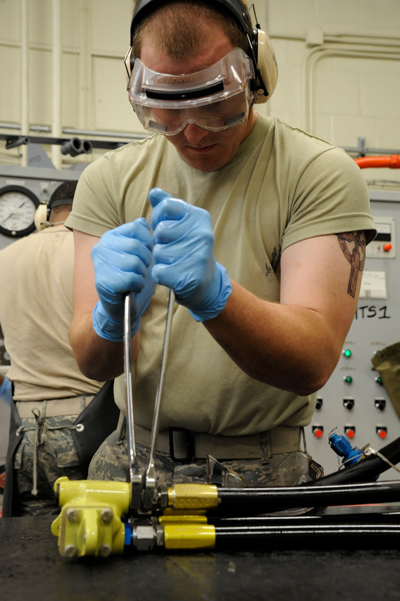 Airman 1st Class Andrew Browning, 2nd Maintenance Squadron Accessories Flight Hydraulics, tightens hydraulic lines on a sliding sleeve assembly on Barksdale Air Force Base, La., April 1. When a pilot wants to fly a certain direction, the assembly moves back and forth and pushes hydraulic fluid which moves the flaps of the wings. (U.S. Air Force photo/Airman 1st Class Andrew Moua)