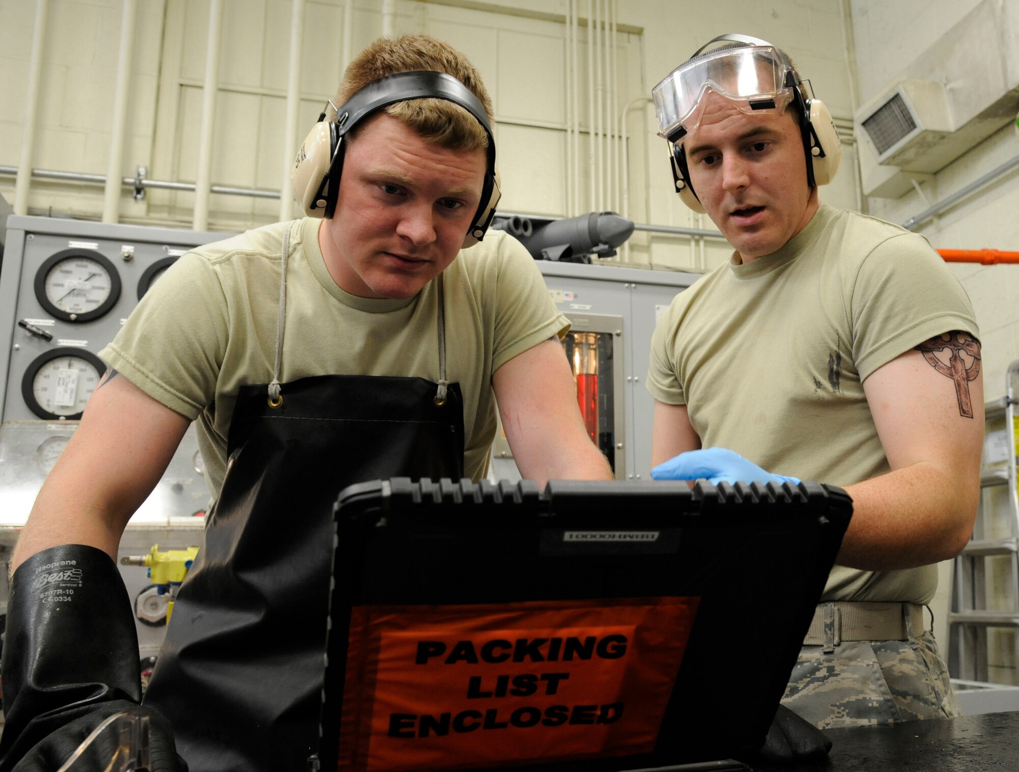 Senior Airman Jeremy Smith and Airman 1st Class Andrew Browning, 2nd Maintenance Squadron Accessories Flight Hydraulics, look over a technical order on Barksdale Air Force Base, La., April 1. TOs are step-by-step instruction manuals used by maintenance Airmen that list proper tools needed, any hazards to be aware of and protective gear to accomplish the task. (U.S. Air Force photo/Airman 1st Class Andrew Moua)