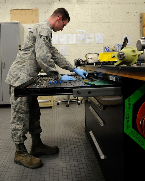 Senior Airman Richard Cota, 2nd Maintenance Squadron Accessories Flight Hydraulics, looks for the proper tool to finish assembling a bomb door actuator on Barksdale Air Force Base, La., April 1. Bomb door actuators are one of many important pieces on the B-52H Stratofortress hydraulics Airmen maintain. The actuator allows the B-52 to open its bomb bay doors to deliver precision munitions to the battlefield. (U.S. Air Force photo/Airman 1st Class Andrew Moua)