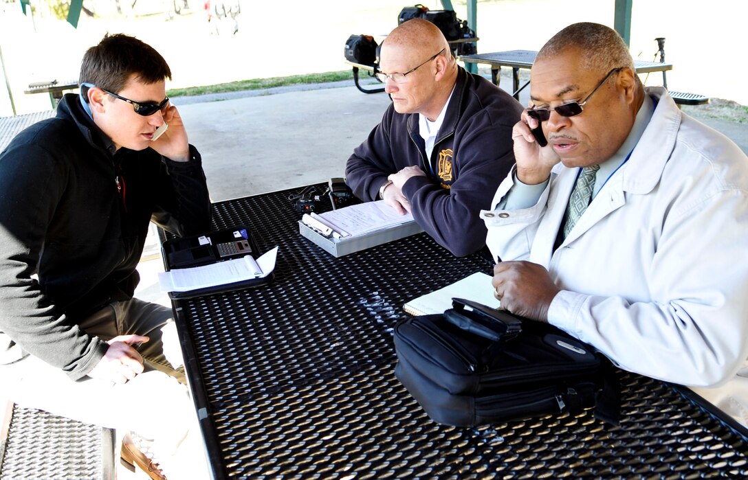 Public Affairs officials from the city of Hampton, Va., and Langley Air Force Base communicate with their respective emergency operation centers during an F-22 Raptor crash exercise March 28, 2013. The exercise allowed emergency responders from Hampton and Langley to work together and solidify their plan if such an event should occur. (U.S. Air Force photo by Staff Sgt. Wesley Farnsworth/Released)