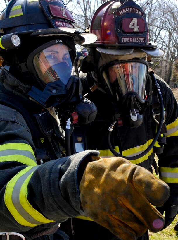 Firefighters with the city of Hampton respond during an F-22 Raptor crash exercise conducted by the city and Langley Air Force Base, March 28, 2013. The exercise allowed emergency responders from Hampton and Langley to work together and solidify their plan if such an event should occur. (U.S. Air Force photo by Staff Sgt. Wesley Farnsworth/Released)