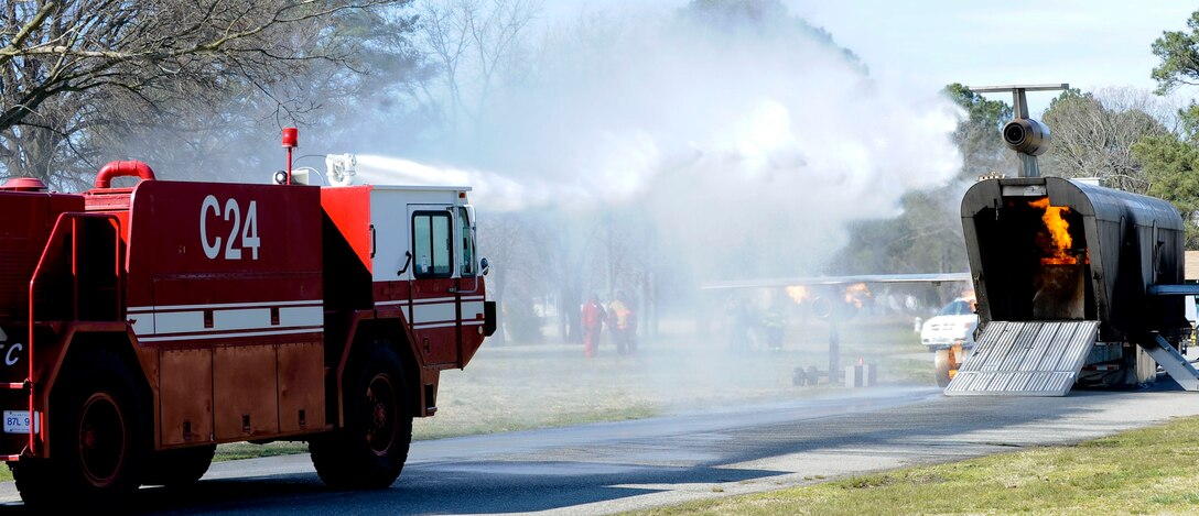 Firefighters from the 633rd Civil Engineer Squadron use a truck to battle a fire on an aircraft burn simulator during an F-22 Raptor crash exercise conducted by the city of Hampton, Va., and Langley Air Force Base, March 28, 2013. The exercise allowed emergency responders from Hampton and Langley to work together and solidify their plan if such an event should occur. (U.S. Air Force photo by Staff Sgt. Wesley Farnsworth/Released)