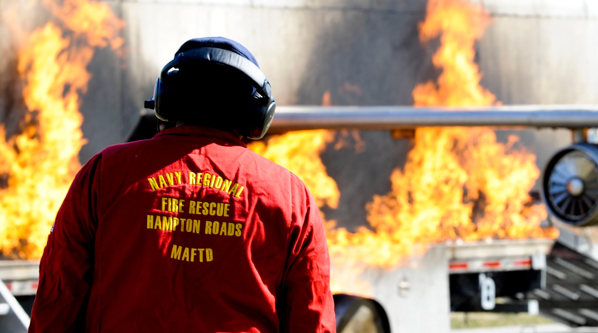 A member of the U.S. Navy Regional Fire Rescue unit tests an F-22 Raptor burn simulator before the start of a crash exercise conducted by the city of Hampton, Va., and Langley Air Force Base, March 28, 2013. The mock aircraft frame features propane hoses running along the inside and outside of the body, and allows crews to control the intensity and scope of a fire during training exercises. (U.S. Air Force photo by Staff Sgt. Wesley Farnsworth/Released)