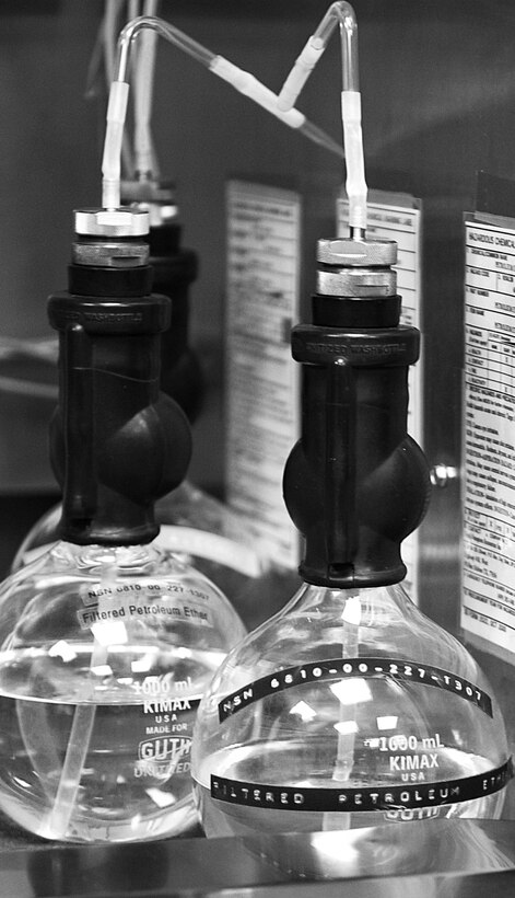 Filter petroleum ether and isopropyl alcohol are used to clean residual fuel between testing to make certain there is no cross contamination. A gallon of fuel is only measured as a true gallon when it is at 60 degrees Fahrenheit, so the Langley Air Force Base fuels laboratory must be kept at this temperature to make certain that all tests are accurate. (U.S. Air Force photo by Senior Airman Brittany Paerschke-O’Brien/Released)