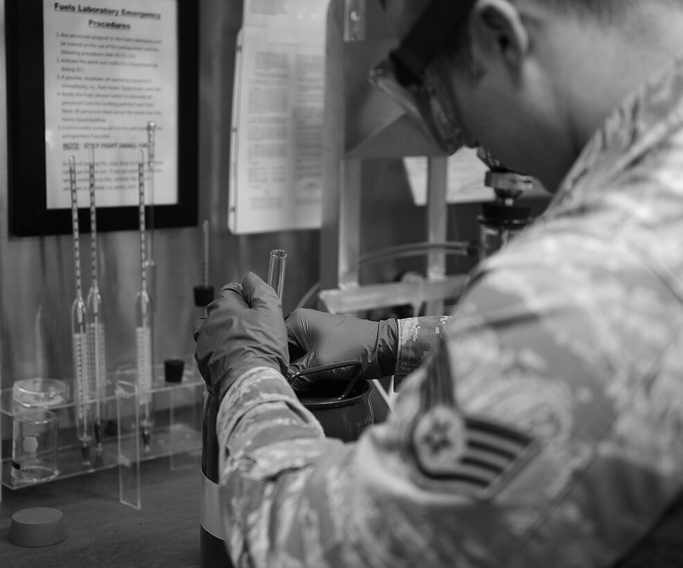 Staff Sgt. Jacob Brake, 633rd Logistics Readiness Squadron fuel laboratory supervisor, tests fuel for particulate contamination at Langley Air Force Base, Va., March 14, 2013. All fuel must be sampled after arriving on base to ensure that it is clean, pure and dry. (U.S. Air Force photo by Senior Airman Brittany Paerschke-O’Brien/Released)