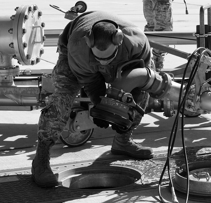 Senior Airman John Justiniano, 633rd Logistics Readiness Squadron fuels distribution operator, disconnects a pantograph for the underground hydrant system at Langley Air Force Base, Va., March. 14, 2013. The three-mile-long underground hydrant system allows fuel from the tank farm to be easily transported to the flight line. (U.S. Air Force photo by Senior Airman Brittany Paerschke-O’Brien/Released)