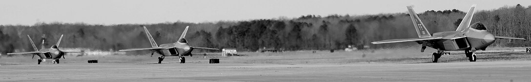 F-22 Raptors taxi across the flight line to be refueled at Langley Air Force Base, Va., March. 14, 2013.  A three-mile-long underground hydrant system allows fuel to flow directly to the flight line for a fast hot-refuel operation.  (U.S. Air Force photo by Senior Airman Brittany Paerschke-O’Brien/Released)