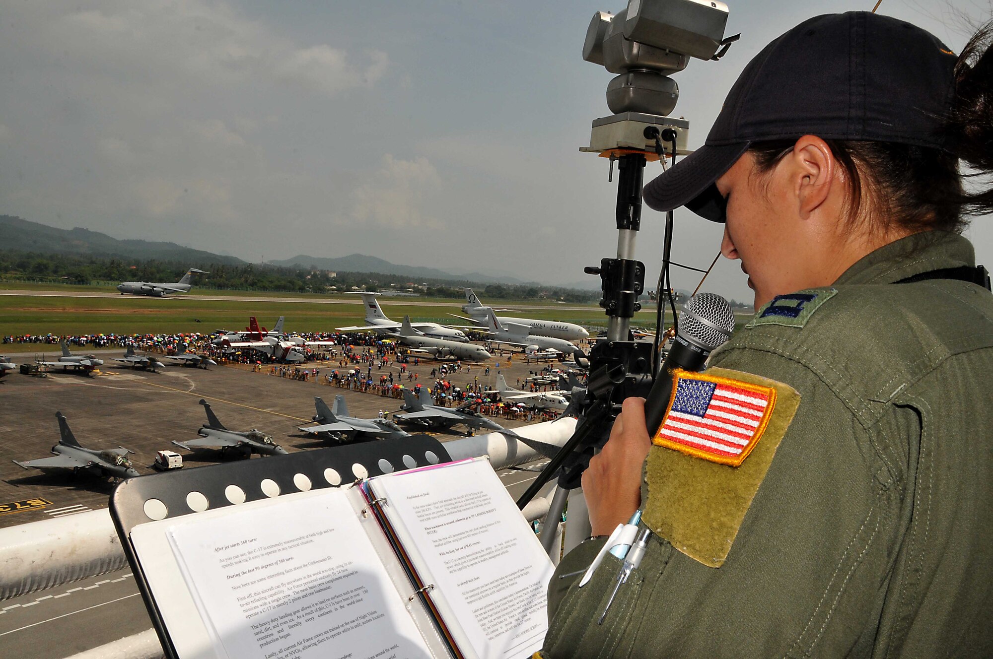 Capt. Angela Kimler of the 535th Airlift Squadron, announces for her team during aerial demonstrations at the 2013 Langkawi International Maritime and Aerospace Exhibition (LIMA 13) March 29, 2013, at Langkawi, Malaysia. Kimler and her Squadron are supporting the 4-exhibition March 26-30 with tours and aerial demonstrations of the C-17 Globemaster III. LIMA 13 provides a forum to showcase U.S. and foreign assets while forming relationships that ultimately contribute to increased interoperability with militaries of other countries.  (U.S. Navy photo/Mass Communication Specialist 1st Class Michelle Lucht) 