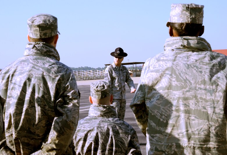 Tech. Sgt. Chi Yi, Military Training Instructor at Officer Training Shool here, demonstrates proper facing movements for new OTS trainees Feb 28. Yi has been an MTI for more than four years. (U.S. Air Force photo by Staff Sgt. Sandra Percival)