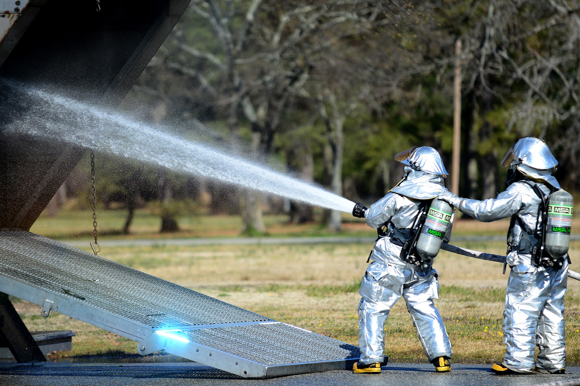 Firefighters from Langley Air Force Base, Va., extinguish a simulated F-22 Raptor crash in the city of Hampton’s Gosnold Hope Park, March 28, 2013. The exercise was designed to help the city of Hampton and Langley Air Force Base first responders work more effectively together in the event of a real-world emergency. (U.S. Air Force photo by Senior Airman Kayla Newman/Released)
