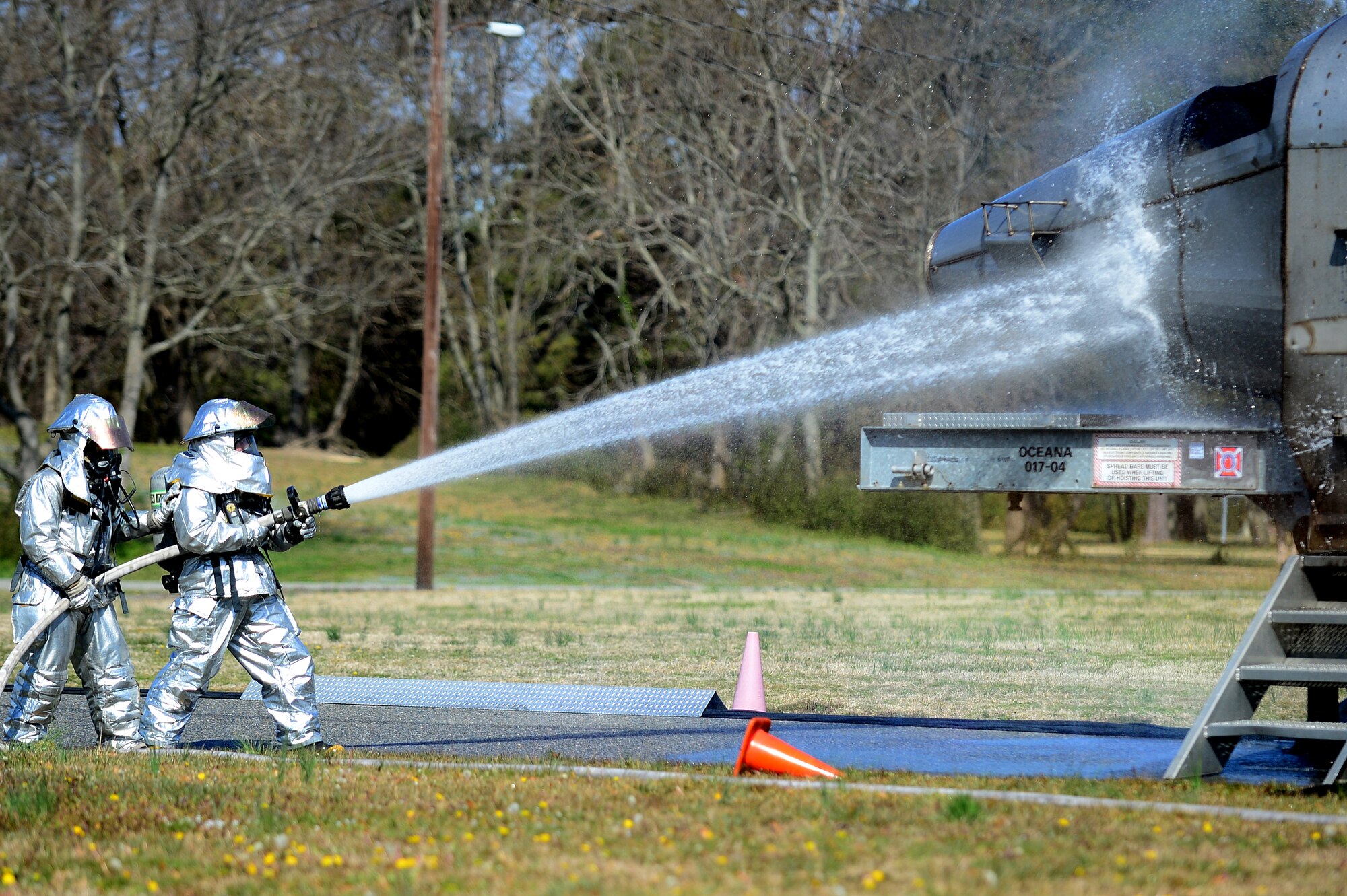 Firefighters from Langley Air Force Base, Va., extinguish a simulated F-22 Raptor crash in the city of Hampton’s Gosnold Hope Park, March 28, 2013. The exercise was designed to help the city of Hampton and Langley Air Force Base first responders work more effectively together in the event of a real-world emergency. (U.S. Air Force photo by Senior Airman Kayla Newman/Released)