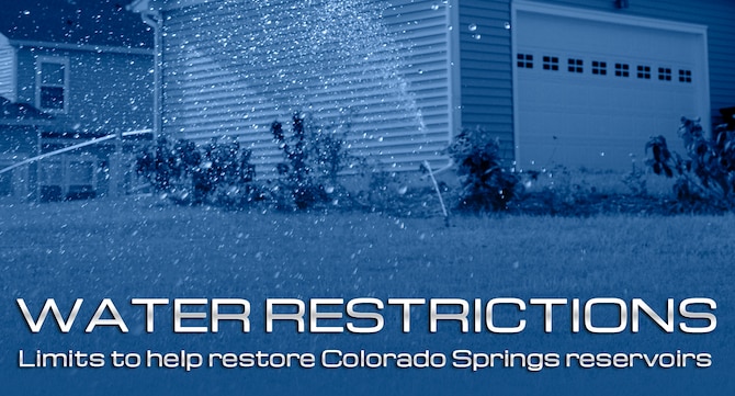 A sprinkler waters two lawns in base housing at Whiteman Air Force Base, Mo., July 28, 2011. Water restrictions set into place by the Colorado Springs City Council will affect housing residents at the Air Force Academy. (U.S. Air Force photo/Airman 1st Class Cody H. Ramirez)