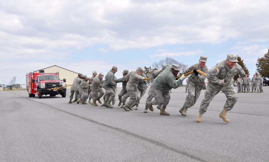 In observance of Women’s History Month, members of Air Force Mortuary Affairs Operations participated in a fire truck pull March 29, 2013, on Dover Air Force Base, Del. The AFMAO team pulled a fire truck across the finish line the fastest, topping four 14-person teams for the win. (U.S. Air Force photo/Tech. Sgt. Ali Rose)