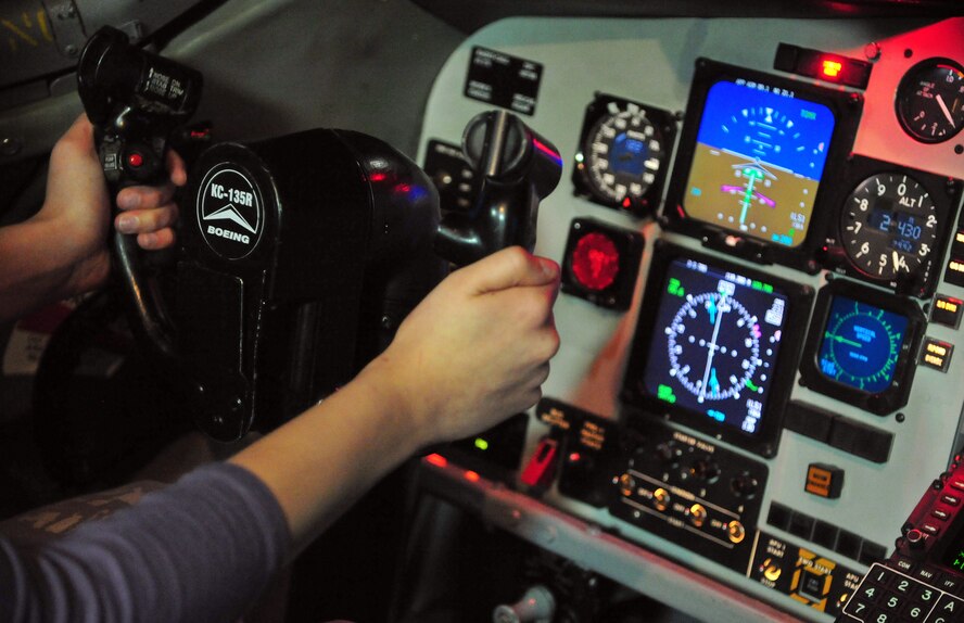 Lilac Princess Devyn Russell operates in the KC-135 Stratotanker simulator, a training tool pilots use daily at Fairchild Air Force Base, Wash., March 28, 2013. The 2013 Lilac Festival court visited many squadrons on base during a tour and Michael Anderson Elementary School where they read to students. (U.S. Air Force photo by Senior Airman Earlandez Young)