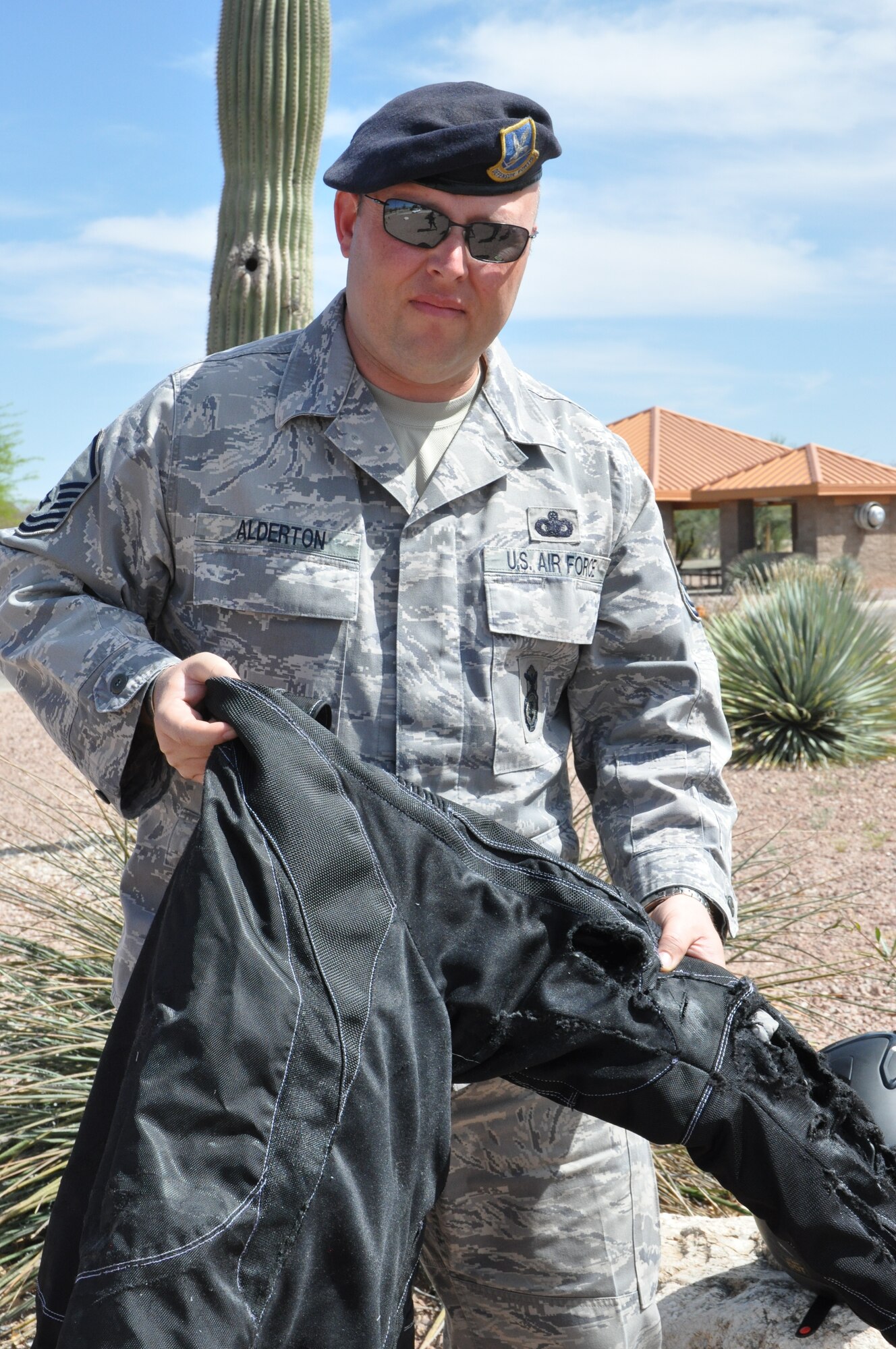 Master Sgt. David Alderton, 12th Air Force (Air Forces Southern) Force Protection, shows off the damage to his Kevlar motorcycle jacket after surviving a near fatal motorcycle accident on interstate 19 in Tucson, Ariz., March 27. (USAF photo by Master Sgt. Kelly Ogden/Released). 