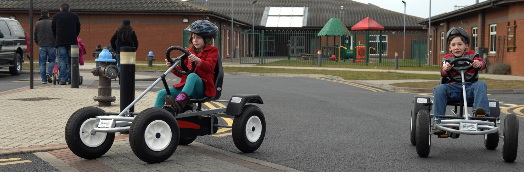 Team Mildenhall children race around a track in pedal-carts March 30, 2013, following an Easter egg hunt at the RAF Mildenhall Youth Programs center, England. The children had the opportunity to play games, eat food and hunt for eggs during the event. (U.S. Air Force photo by Airman 1st Class Dillon Johnston/Released)
