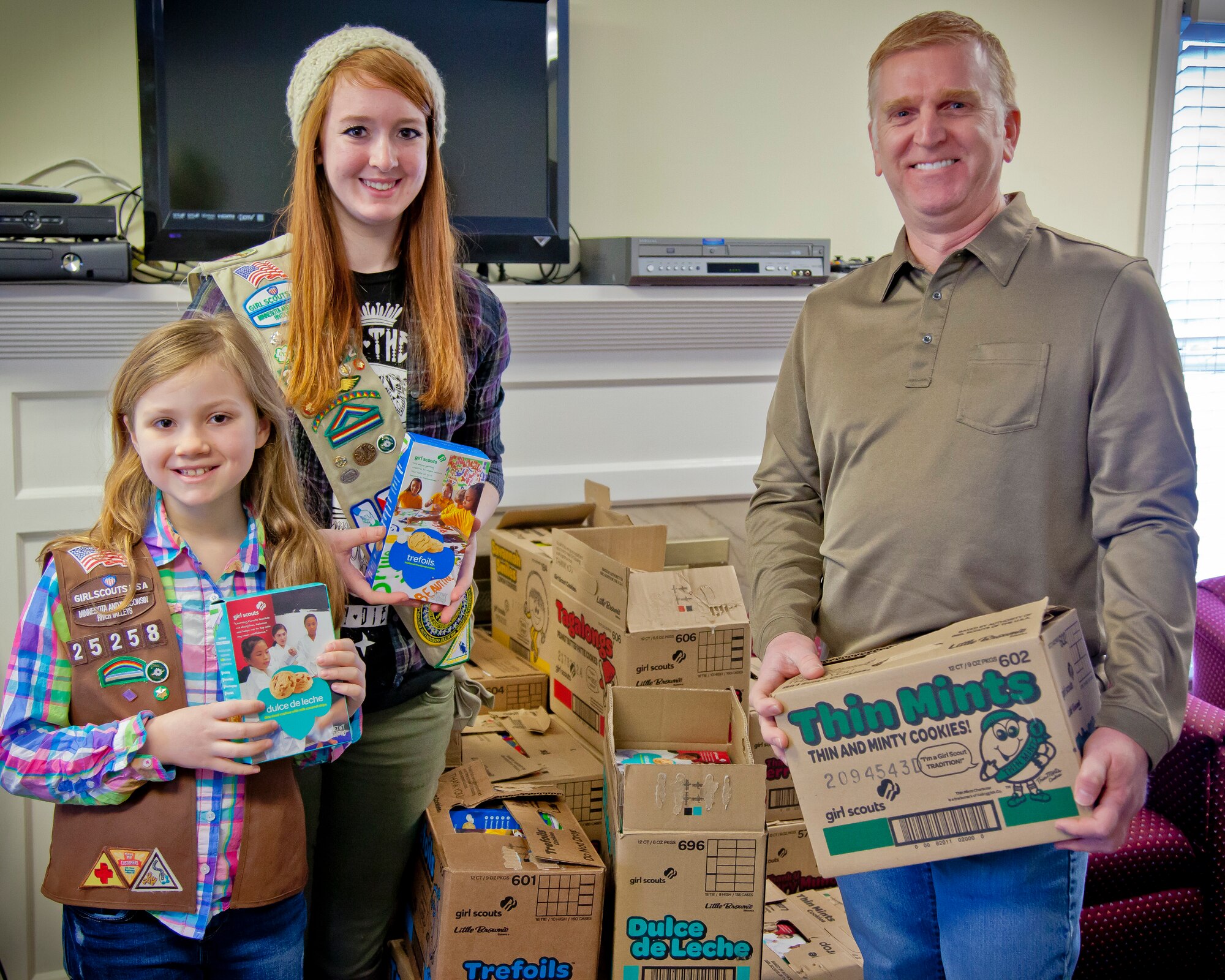 Girl Scouts Ainsley and Alexa Nutt, of Northfield GS Troops 25258 and 22642, delivered over 450 boxes of donated cookies on behalf of their troops to Michael Sanford, 934th Airmen and Family Readiness, at the Minneapolis-St. Paul Air Reserve Station, Minn.  (U.S. Air Force photo/Shannon McKay)