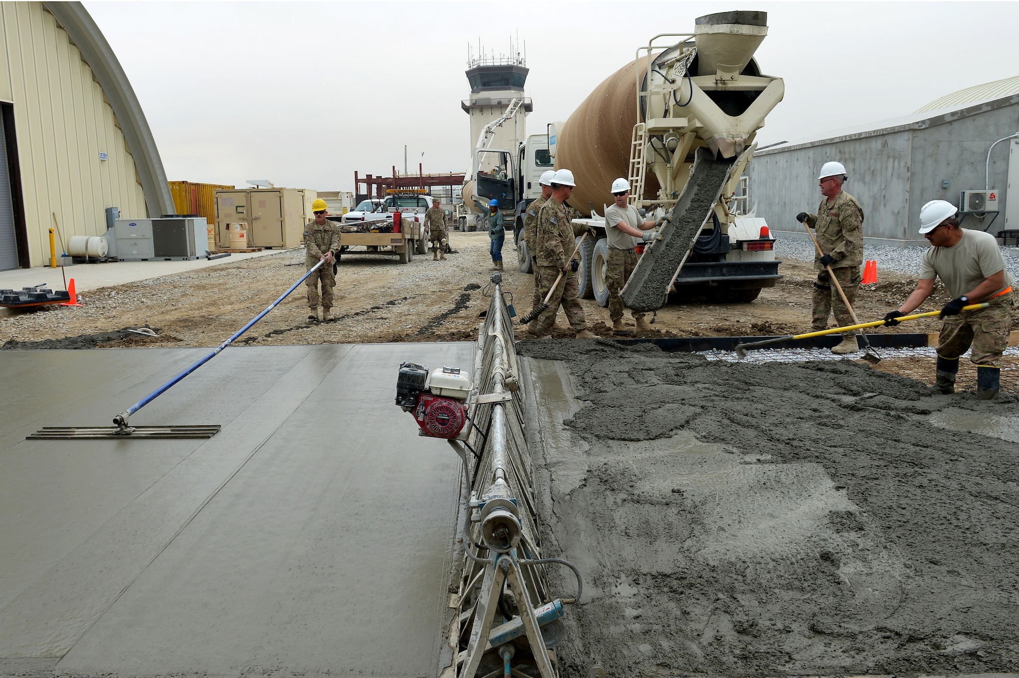 Members of the 455th Expeditionary Civil Engineer Squadron spread concrete during a project on Bagram Airfield, Afghanistan, March 27, 2013. The 455th ECES have poured 83.5 cubic meters of concrete for 11 separate sites in the past three months. (U.S. Air Force photo/Senior Airman Chris Willis)
