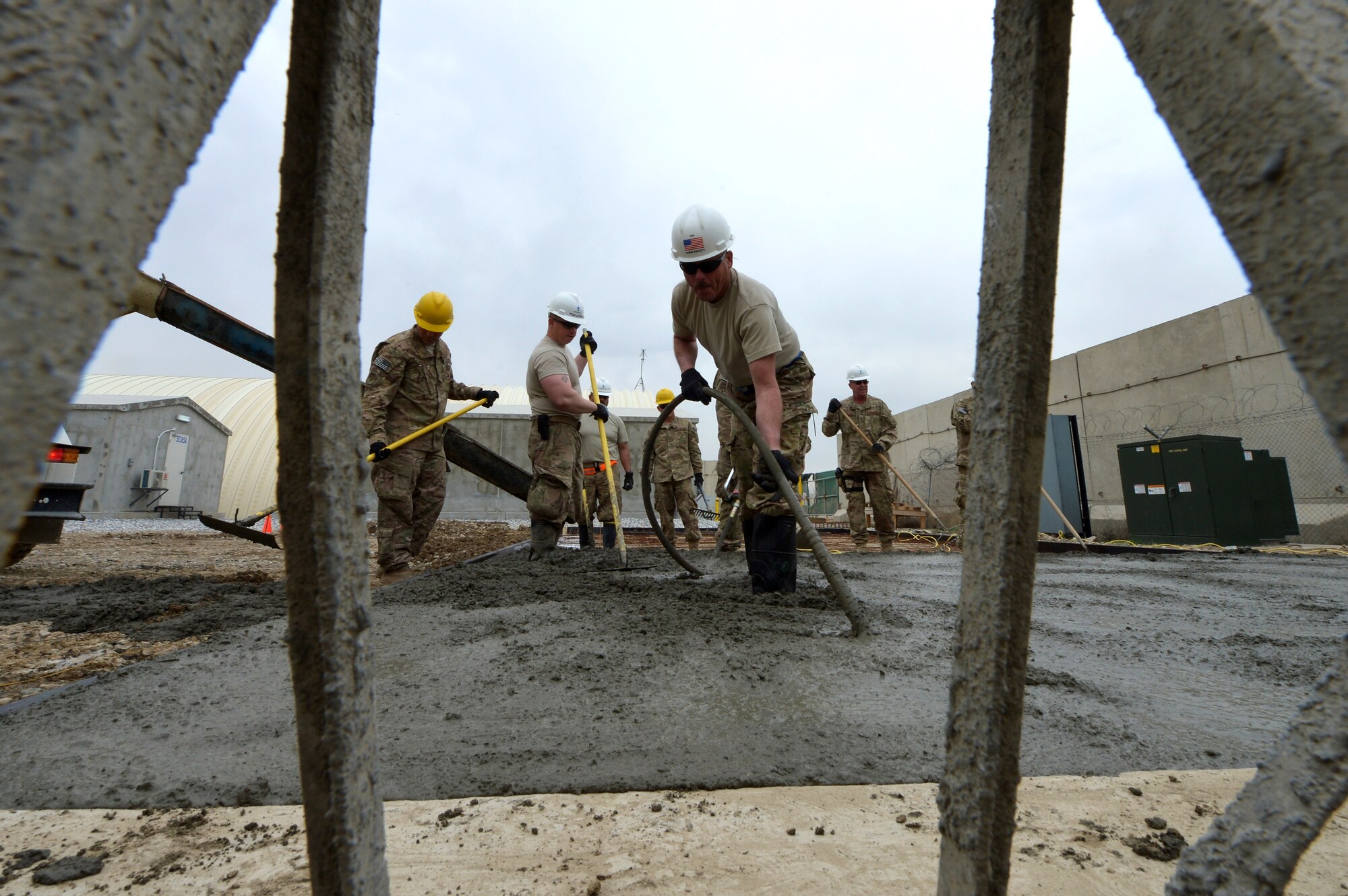 Members of the 455th Expeditionary Civil Engineer Squadron spread concrete during a project on Bagram Airfield, Afghanistan, March 27, 2013. The 455th ECES have poured 83.5 cubic meters of concrete for 11 separate sites in the past three months. (U.S. Air Force photo/Senior Airman Chris Willis)