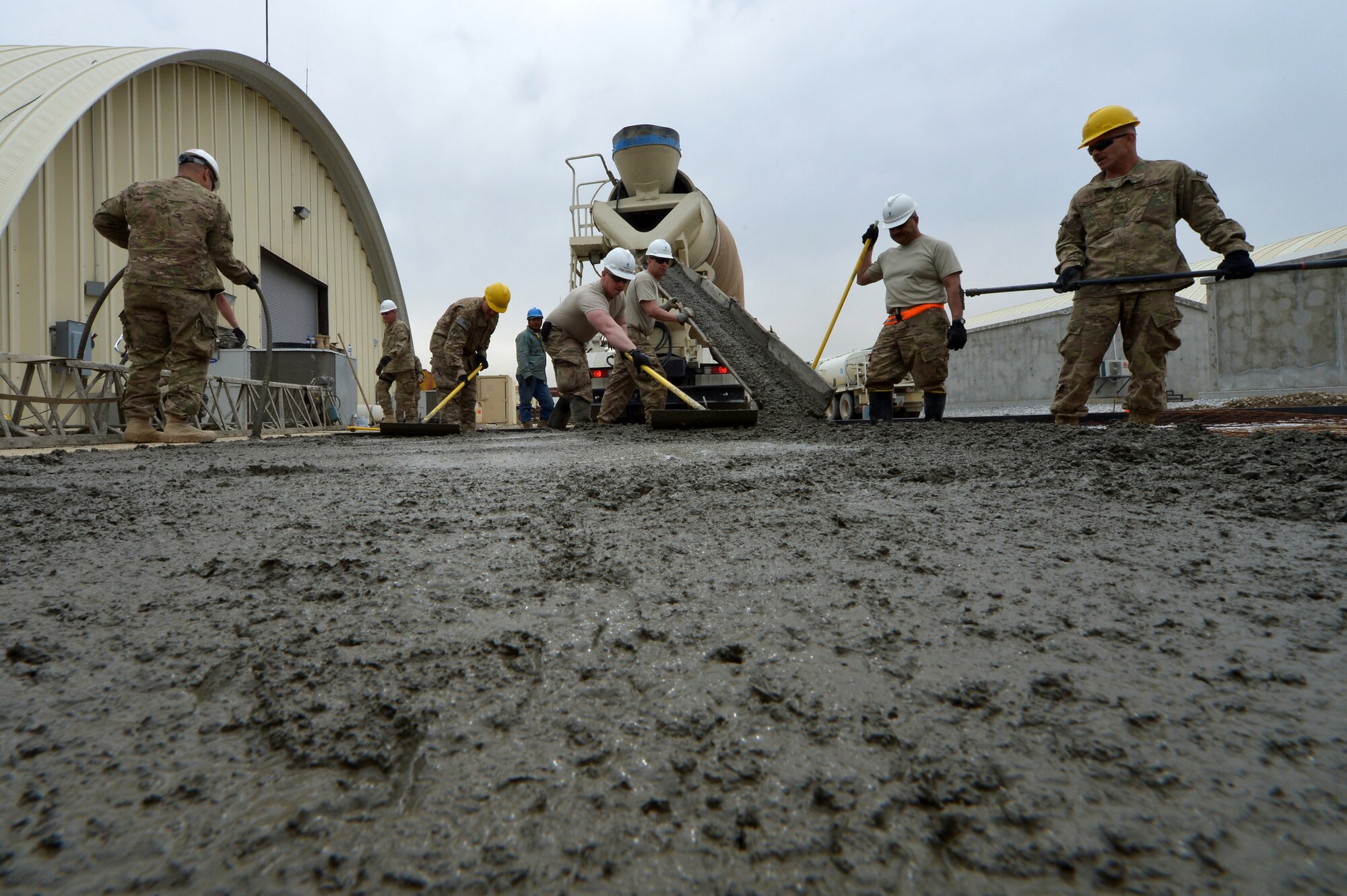 Members of the 455th Expeditionary Civil Engineer Squadron spread concrete during a project on Bagram Airfield, Afghanistan, March 27, 2013. The 455th ECES have poured 83.5 cubic meters of concrete for 11 separate sites in the past three months. (U.S. Air Force photo/Senior Airman Chris Willis)