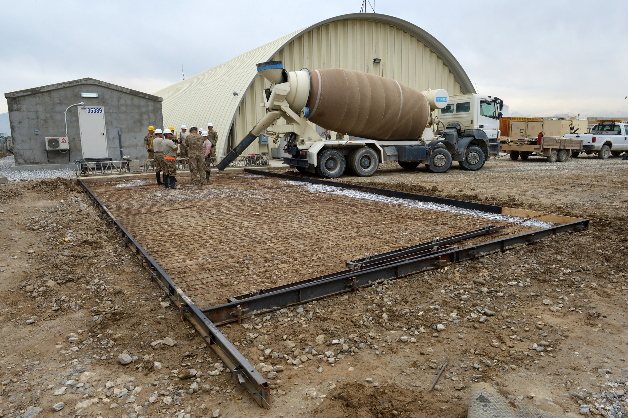 Members of the 455th Expeditionary Civil Engineer Squadron prepare to pour concrete during a project on Bagram Airfield, Afghanistan, March 27, 2013. The 455th ECES have poured 83.5 cubic meters of concrete for 11 separate sites in the past three months. (U.S. Air Force photo/Senior Airman Chris Willis)