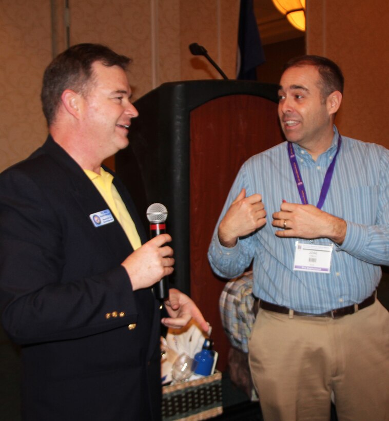 Chaplain (Maj.) David Dersch gives out a Yellow Ribbon welcome gift to Chief Master Segerant Jose Tamayo from the 932nd Aeromedical Evacuation Squadron at Scott Air Force Base.  Chaplain Dersch is from the 908th Airlift Wing, Maxwell Air Force Base, Al., and he was the overall emcee and leader for the Yellow Ribbon event in Norfolk, Va. recently.  The Yellow Ribbon is designed to help deployers understand all the rescources available to them.  (U.S. Air Force photo/Maj. Stan Paregien)