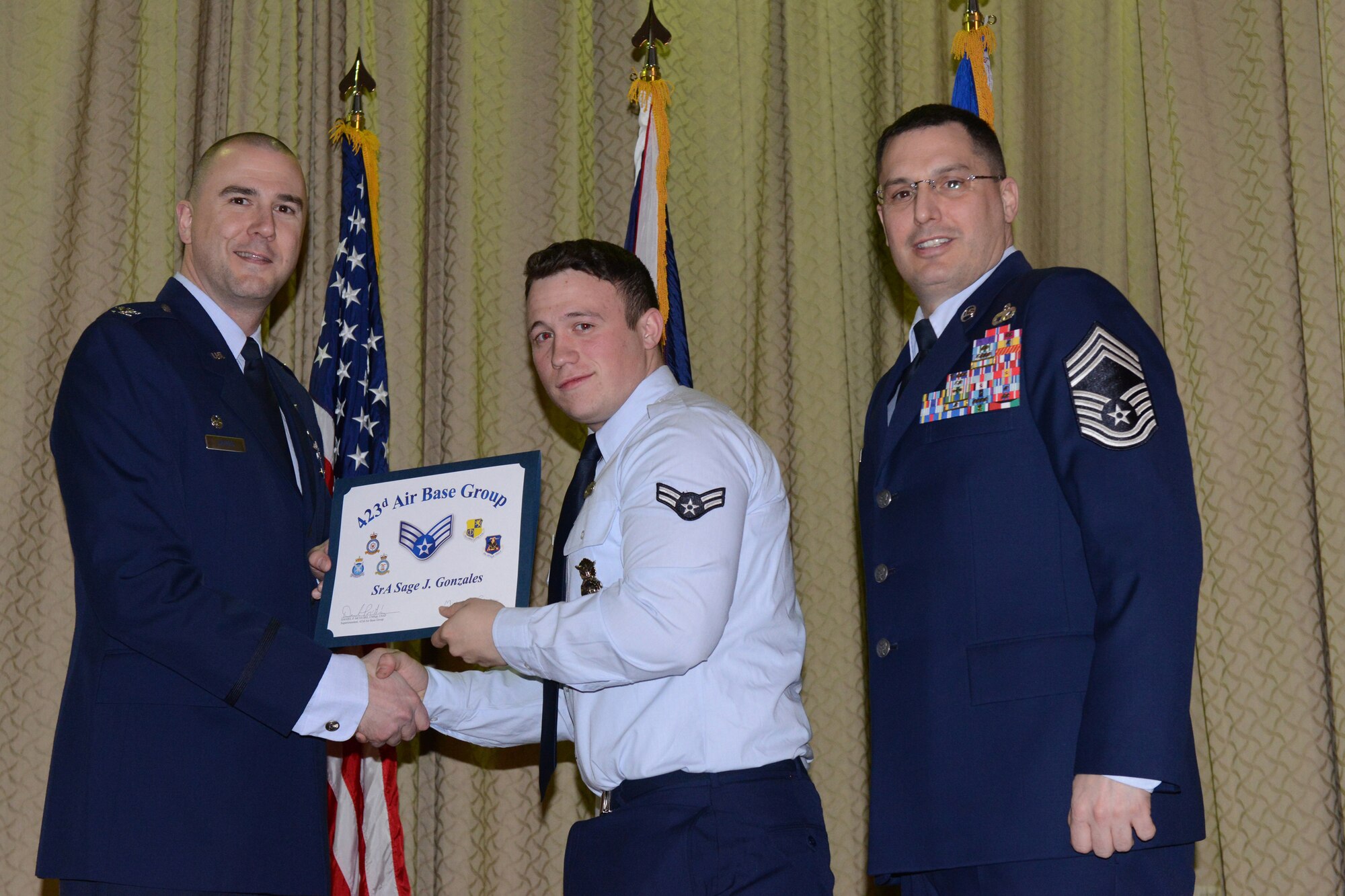 RAF ALCONBURY, United Kingdom – Senior Airman Sage Gonzales, 423rd Security Forces Squadron, receives his certificate for promotion to senior airman March 29 at the RAF Alconbury Theater. (U.S. Air Force photo by Tech. Sgt. Chrissy Best)