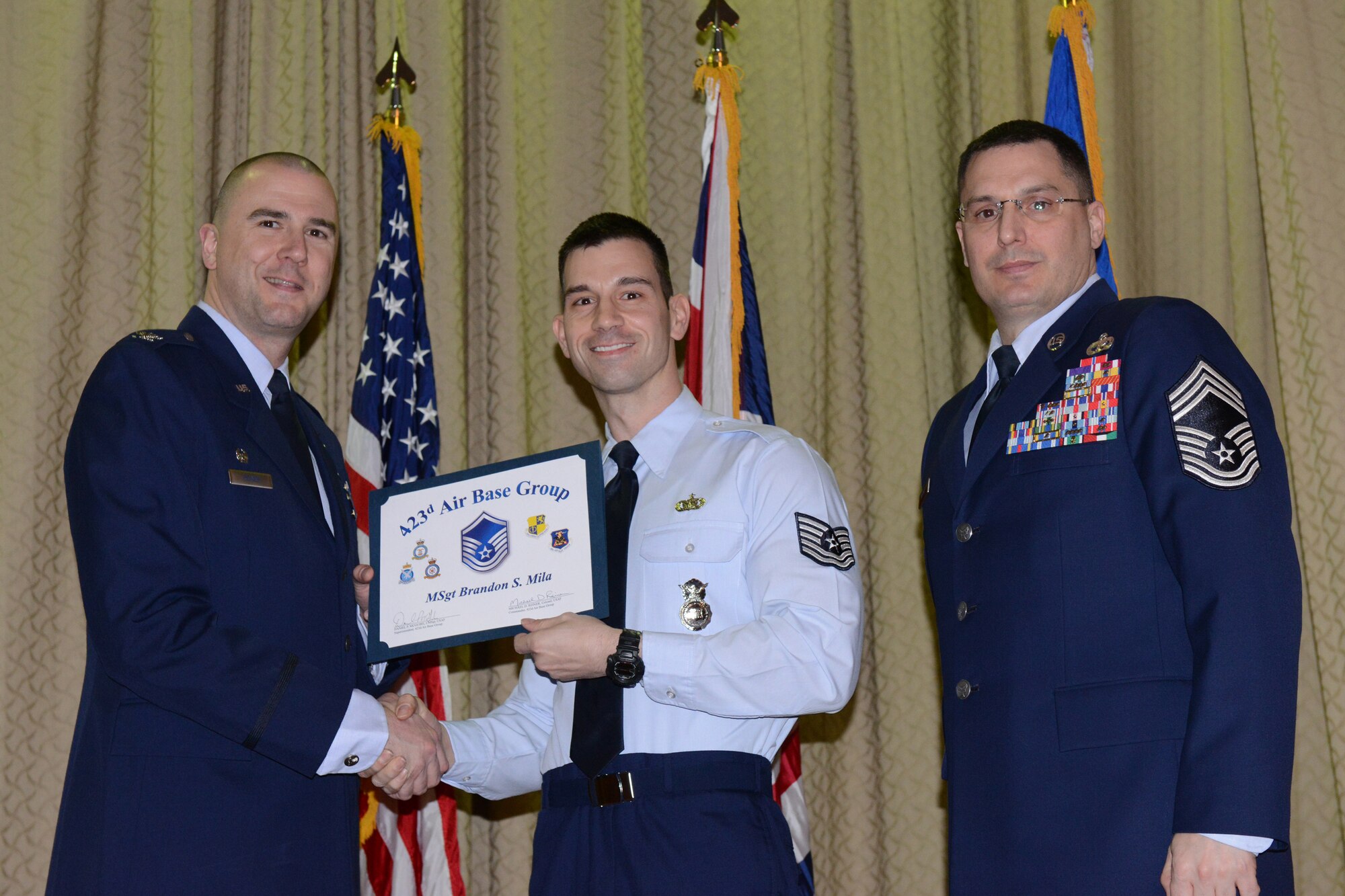 RAF ALCONBURY, United Kingdom – Master Sgt. Brandon Mila, 423rd Security Forces Squadron, receives his certificate for promotion to master sergeant March 29 at the RAF Alconbury Theater. (U.S. Air Force photo by Tech. Sgt. Chrissy Best)