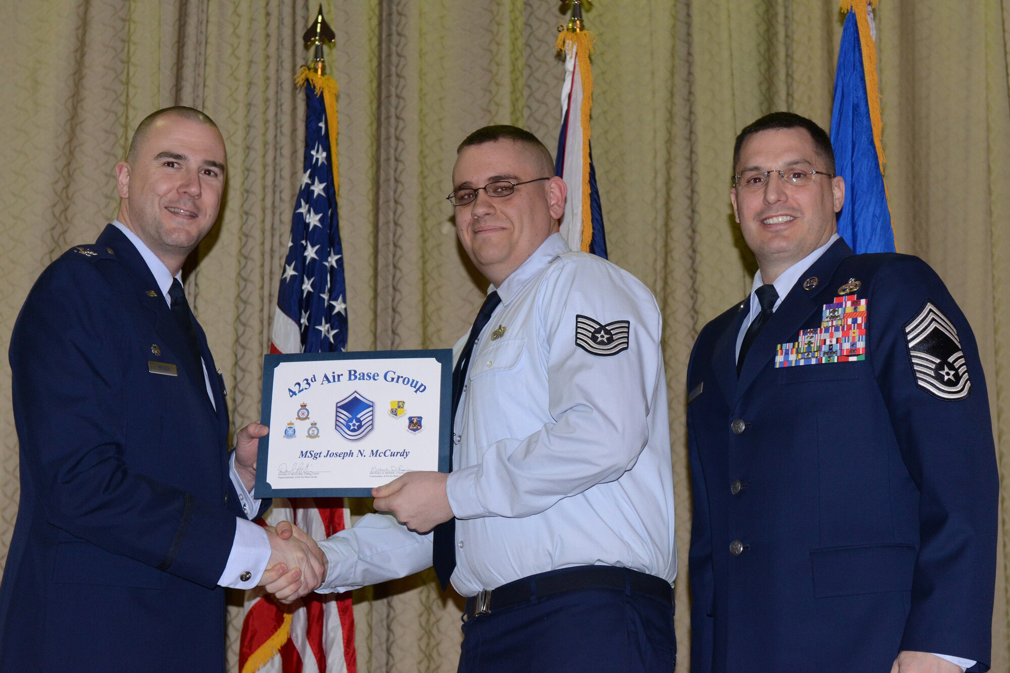 RAF ALCONBURY, United Kingdom – Master Sgt. Joseph McCurdy, 501st Combat Support Wing, receives his certificate for promotion to master sergeant March 29 at the RAF Alconbury Theater. (U.S. Air Force photo by Tech. Sgt. Chrissy Best)