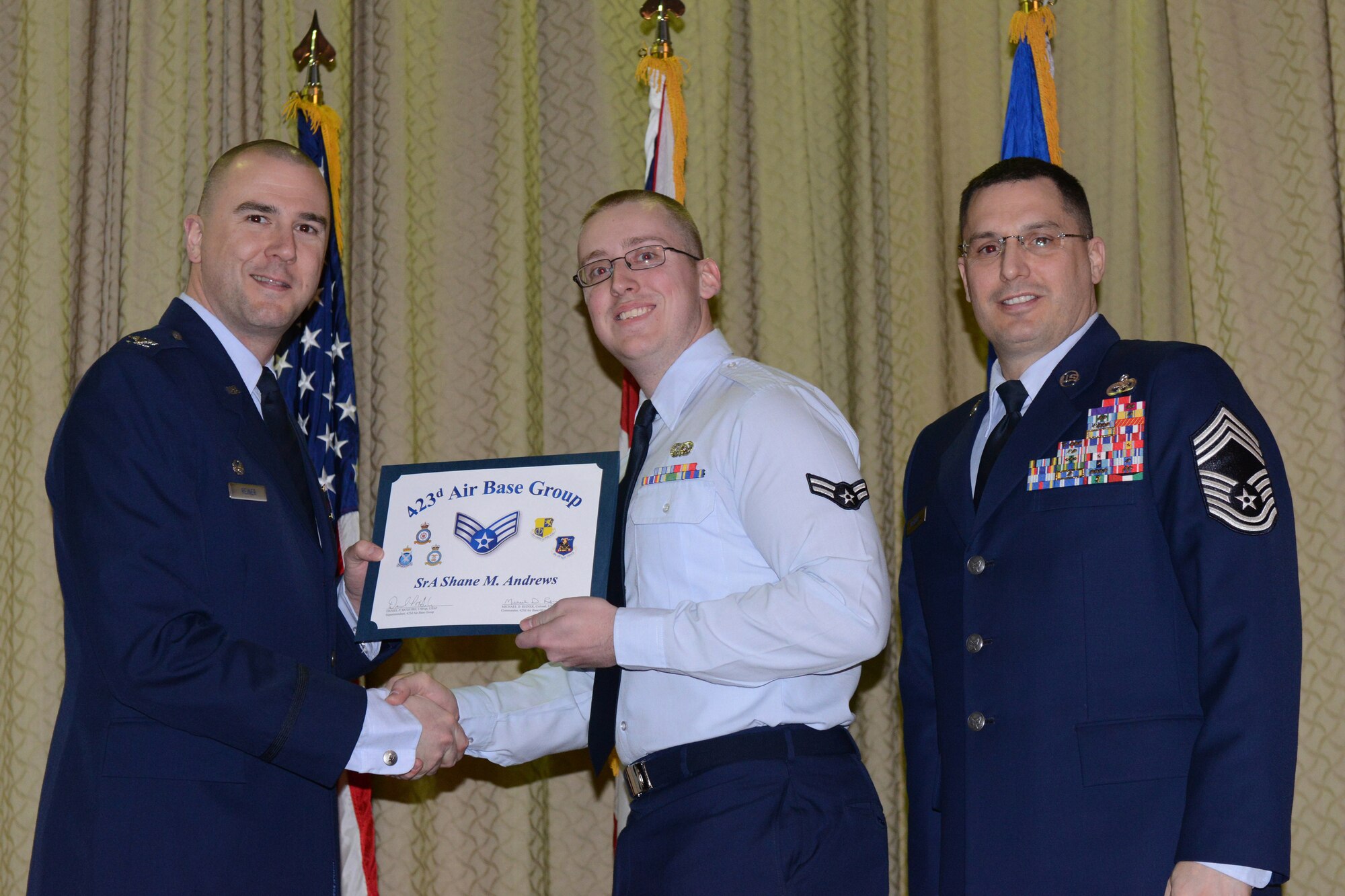 RAF ALCONBURY, United Kingdom – Senior Airman Shane Andrews, 423rd Communications Squadron, receives his certificate for promotion to senior airman March 29 at the RAF Alconbury Theater. (U.S. Air Force photo by Tech. Sgt. Chrissy Best)