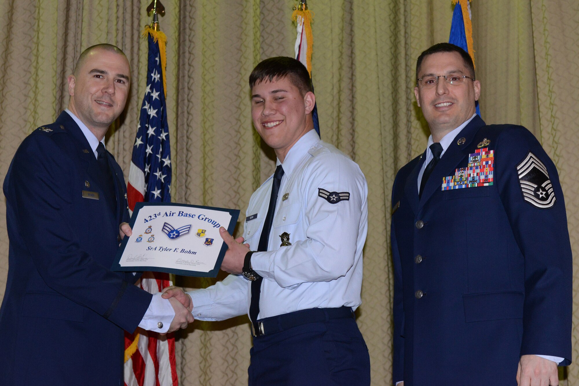 RAF ALCONBURY, United Kingdom – Senior Airman Tyler Bohm, 423rd Security Forces Squadron, receives his certificate for promotion to senior airman March 29 at the RAF Alconbury Theater. (U.S. Air Force photo by Tech. Sgt. Chrissy Best)