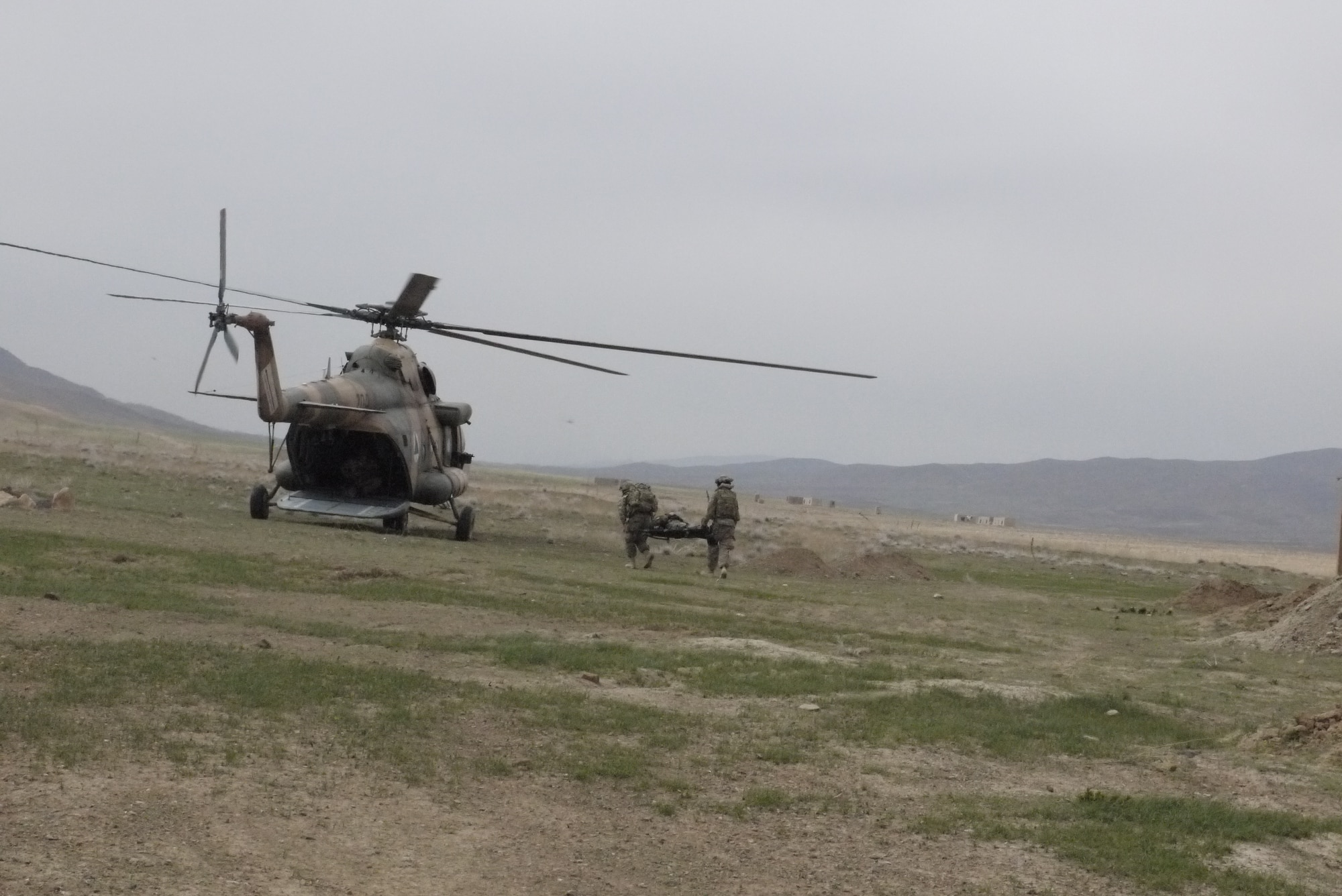 Members of the Afghan Air Force from Kabul Air Wing, Afghanistan implement casualty evacuation procedures for a simulated injury during an exercise March 27, 2013. Members of the AAF and NATO Air Training Command-Afghanistan conducted Operation Shadie Barfie, employing Mi-35 gunships and Mi-17 helicopters in an air assault capacity and Cessna 208s for casualty evacuation response, showcasing the combined operations capability that the AAF has begun to effectively demonstrate on the battlefield. (courtesy photo)