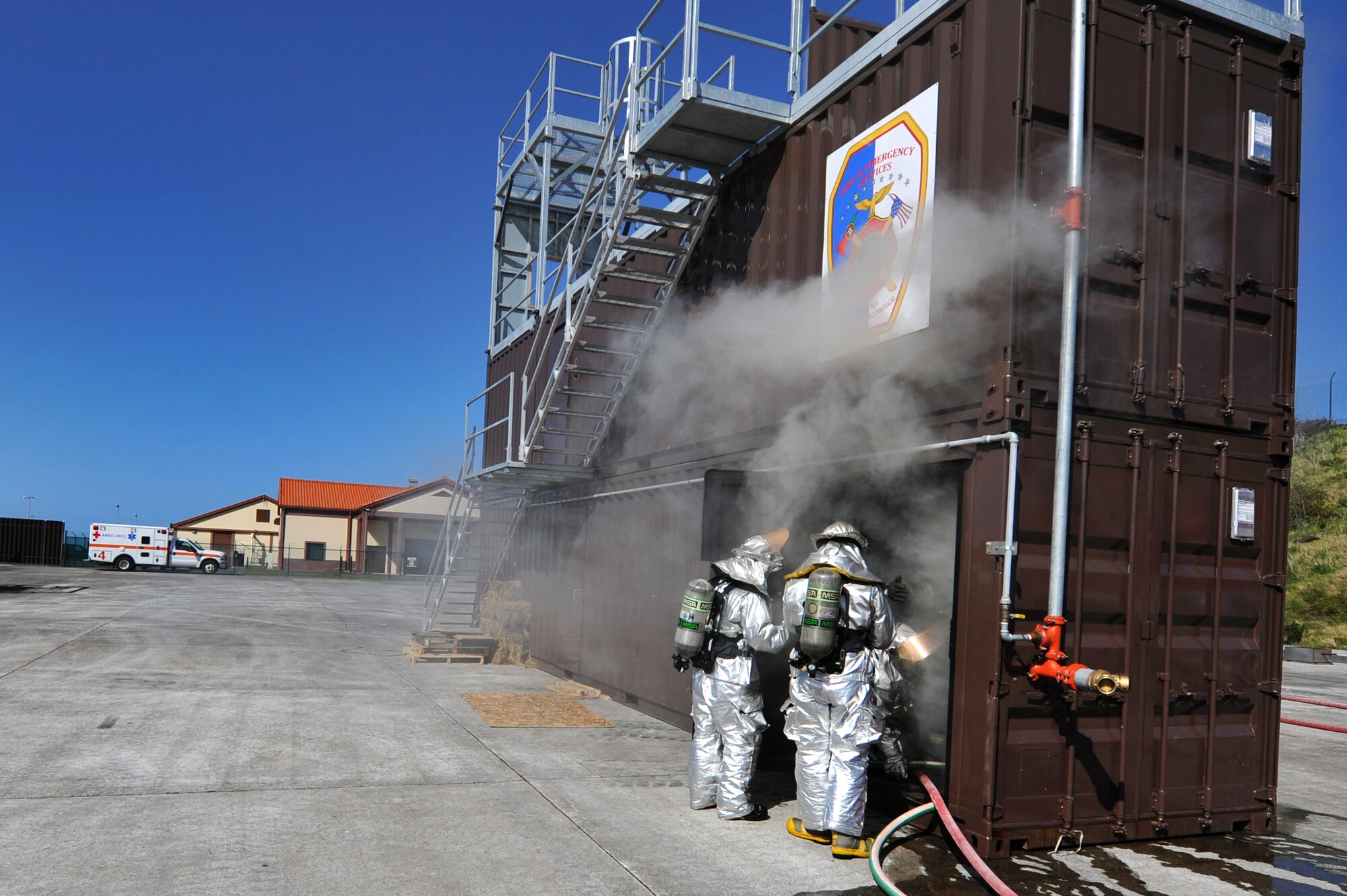 Firefighters from the 65th Civil Engineer Squadron break in their new structural fire trainer, Mar. 29, 2013, Lajes Field, Azores.  The Lajes fire department received a new fire trainer which saves the Air Force an estimated $400K per year in TDY costs and Portuguese overtime pay for off-site training.   The fire department also gains more training opportunities to include rappelling and using litters to evacuate incapacitated people from burning buildings.  (U.S. Air Force photo by Tech. Sgt. Chenzira Mallory)