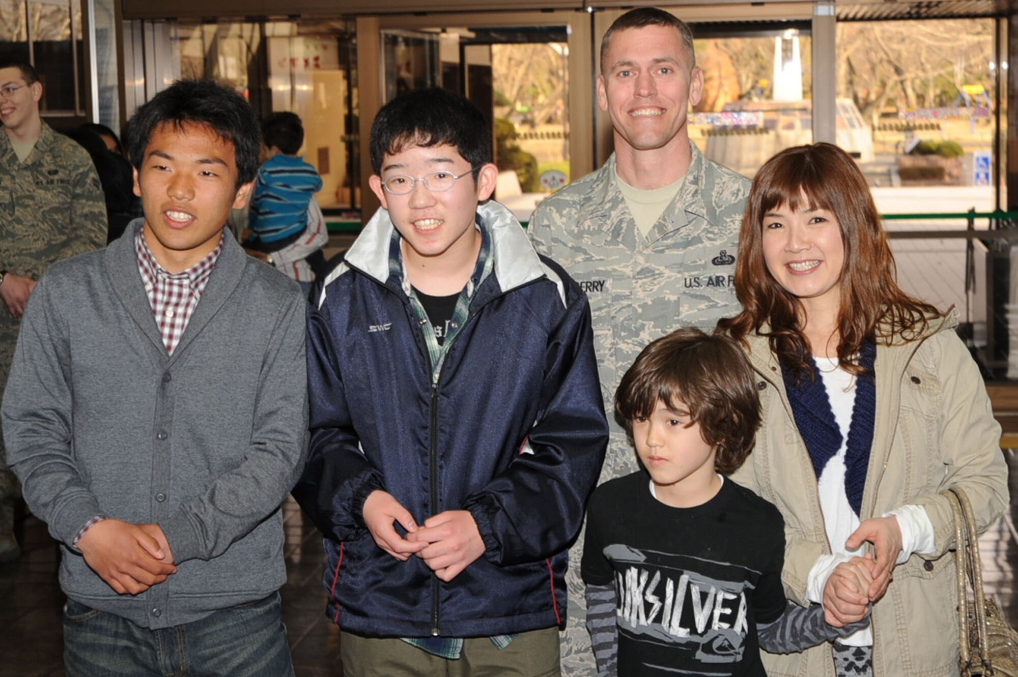 Daisuke Yamamoto, left, and Tomoya Yamamoto, students from Taro Daiichi Junior High School in Miyako City, Japan, stand with the family of U.S Air Force Senior Master Sgt. Michael Stansberry, 35th Communications Squadron, during a Homestay introduction ceremony at the Misawa City Civic Center, Misawa, Japan, March 29, 2013. Air Force families at Misawa Air Base welcomed students as part of the Homestay program, sponsored by the Misawa International Club, which allows local nationals to experience American living and share cultures. (U.S. Air Force photo by Senior Airman Derek VanHorn)